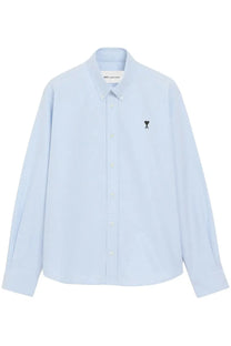 Light blue long-sleeved cotton button-down shirt with small black embroidered heart and a logo on left chest by ami paris