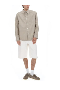 A beige and white vertically striped long-sleeved button-up shirt with a classic collar paired with ami paris men’s white cotton shorts