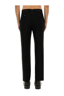 Black tailored ami paris men’s straight fit pants with sleek straight-leg cut and subtle back pleats shown from the back