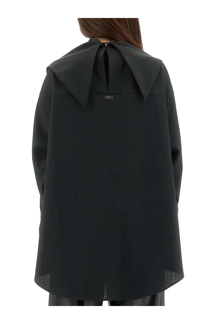 Black oversized cape style top with wide collar and subtle back zipper detail shown from the back side