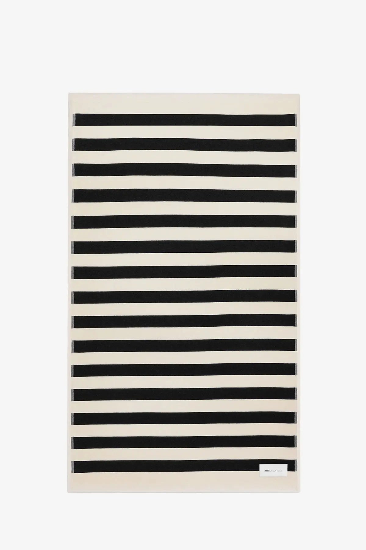 Ami Paris unisex cotton beach towel with bold black and cream horizontal stripes in a rectangular shape