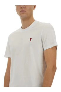 White cotton ami paris unisex shirt with a small red embroidered heart logo on the left chest