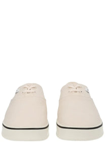 Cream-colored canvas ami paris unisex tennis sneakers with black rubber soles and laces in white