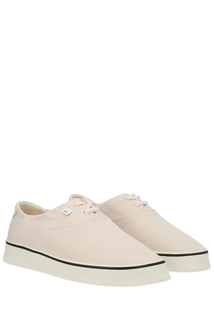 Ami Paris unisex tennis sneaker in cream canvas with white laces and black rubber sole stripe