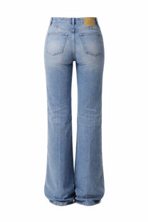 Back view of ami paris women’s light-wash cotton denim flare jeans with classic pockets and tan leather brand tag