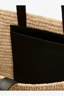 Beige woven straw Ami Paris womens tote bag with black leather handles and sleek black interior lining