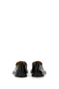 Ami paris women’s black patent leather lace up dress shoes with sleek minimalist design and white stitching along sole