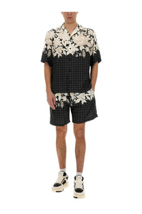 Amiri men’s Bermuda Garden black short-sleeved shirt with black and white floral pattern and checkered lower half