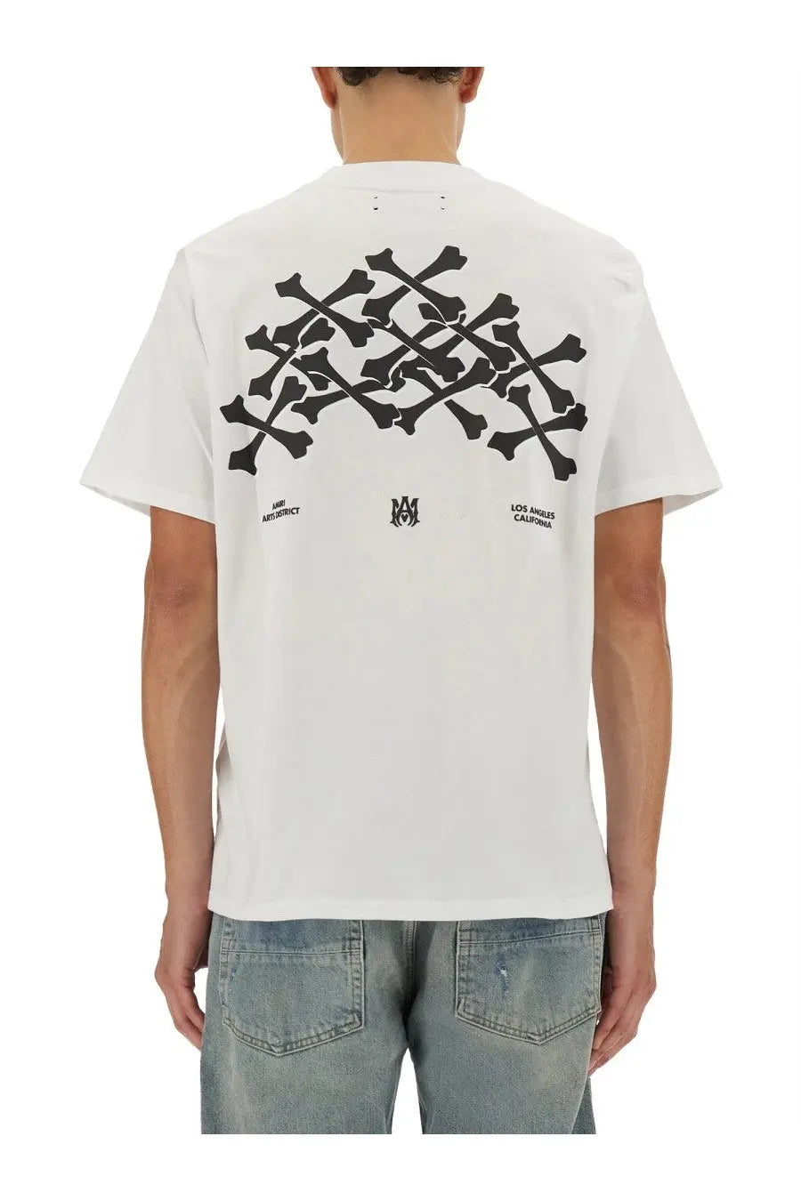 Amiri men’s white cotton short-sleeved t-shirt with bold black skull and crossbones graphic and los angeles california text