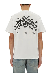 Amiri men’s white cotton short-sleeved t-shirt with bold black skull and crossbones graphic and los angeles california text