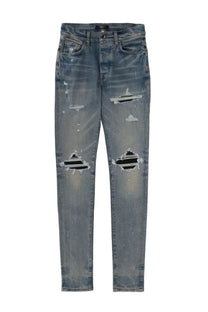Amiri men’s jeans mx1 blue distressed denim jeans with ripped knees and faded wash front view