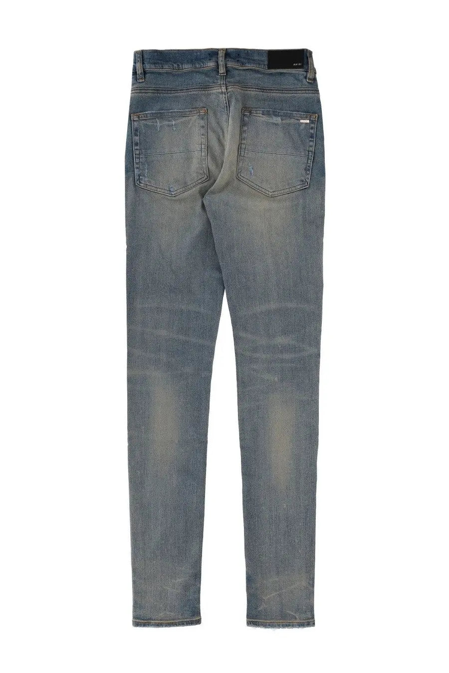 A pair of slim-fit amiri men’s jeans mx1 in medium-wash blue denim with subtle fading and distressed details