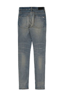A pair of slim-fit amiri men’s jeans mx1 in medium-wash blue denim with subtle fading and distressed details