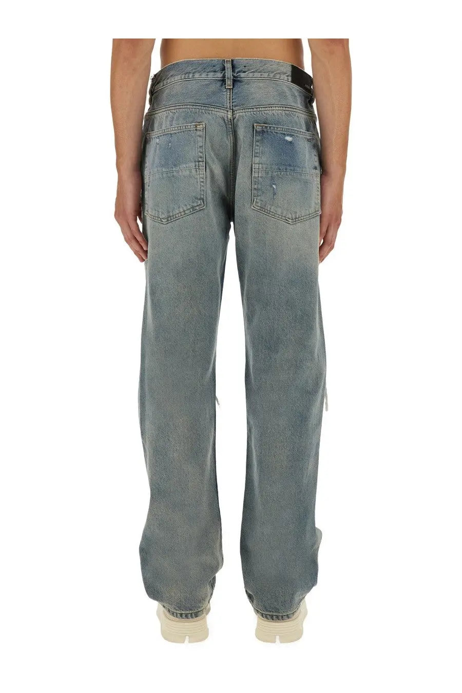 Amiri men’s washed blue denim jeans with relaxed fit and distressed details