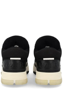 Back view of amiri men’s sneaker ma black with mesh upper cream rubber sole and embossed branding on heel