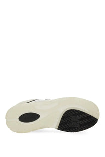Back view of amiri men’s white and black athletic sneaker with chunky sole and ariat embossed patch near the heel