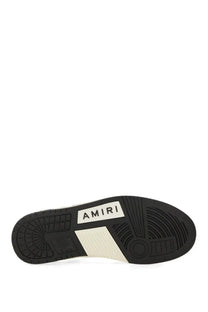 Black rubber sole with white amiri branding and geometric tread on AMIRI men’s sneaker skel black back side