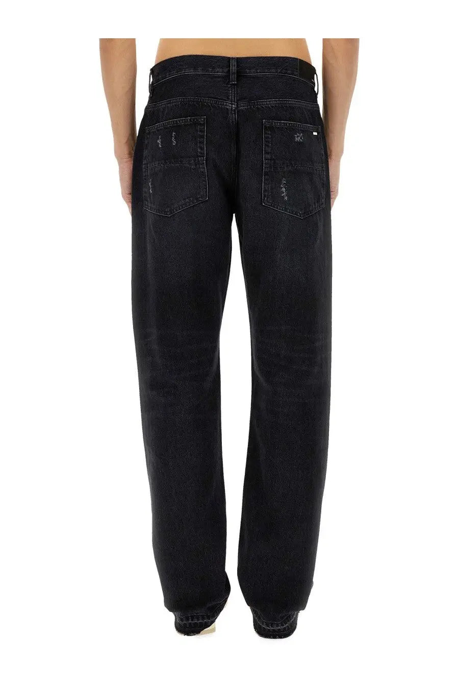 Amiri men’s straight leg black denim jeans with distressed faded finish and subtle stitching details