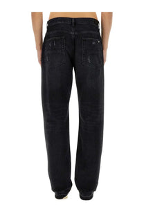 Amiri men’s straight leg black denim jeans with distressed faded finish and subtle stitching details