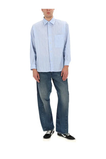 Light blue and white striped button-up shirt with chest pocket paired with amish supplies men’s jeans twist slub blue