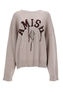 Beige knit sweater with amish lettering in dark brown and geometric macrame pendant design for women