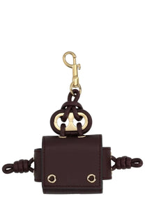 Dark brown leather anya hindmarch women’s earphone case with gold-tone metal hardware and distinctive knot design