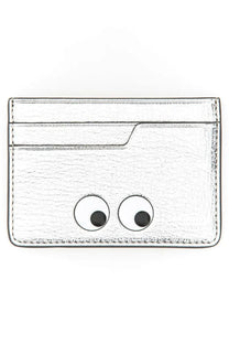 Anya Hindmarch women’s silver textured card holder with playful black and white googly eyes
