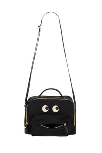 Anya Hindmarch women’s black canvas crossbody bag with playful embroidered eyes and zipper-mouth design