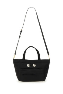 Anya Hindmarch women’s mini black canvas tote bag with playful white embroidered eyes and adjustable shoulder strap
