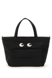 Anya Hindmarch women’s black canvas mini tote bag with playful white and black embroidered eyes on the front