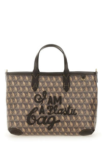 Anya Hindmarch women’s brown and beige patterned tote bag with black leather handles and bold i am a plastic bag script