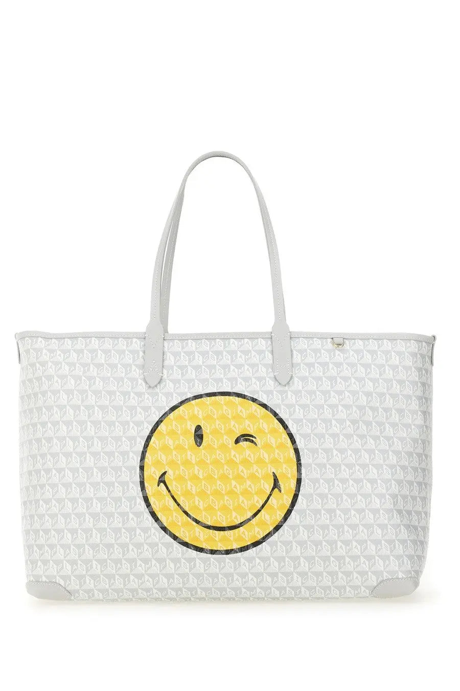 Anya Hindmarch women’s white tote bag with repeating geometric pattern and large yellow winking smiley face front