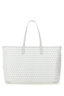 Anya Hindmarch women’s blue AM plastic tote bag with white repeating geometric pattern and matching handles