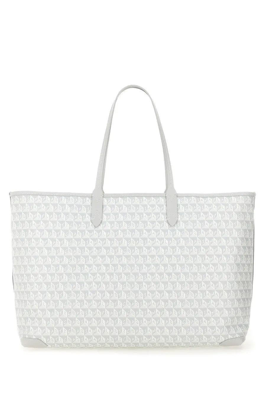 Anya Hindmarch women’s white tote bag with repeating geometric pattern and light gray leather handles