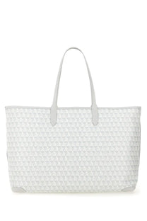 Anya Hindmarch women’s white tote bag with repeating geometric pattern and light gray leather handles