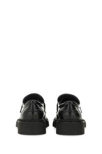 Ash women’s moccasin miracle black black patent leather loafers with chunky rubber soles shown from the back side