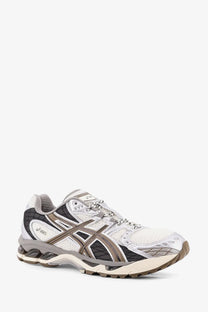 Asics men’s gel nimbus low top mesh sneakers white with gray mesh upper black accents and cushioned sole
