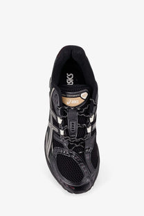 Asics men’s gel nimbus mesh sneakers in black with mesh and synthetic overlays white laces and gold branding details