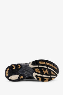 Black and beige rubber sole with textured geometric tread pattern on asics men’s gel nimbus mesh sneakers black