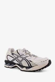 Asics men’s gel nimbus mesh sneakers in white and black with quilted overlays and chunky rubber sole
