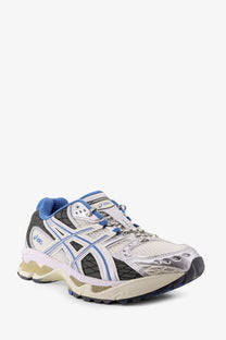 White and blue asics men’s gel nimbus mesh sneaker with mesh upper black accents and silver midsole