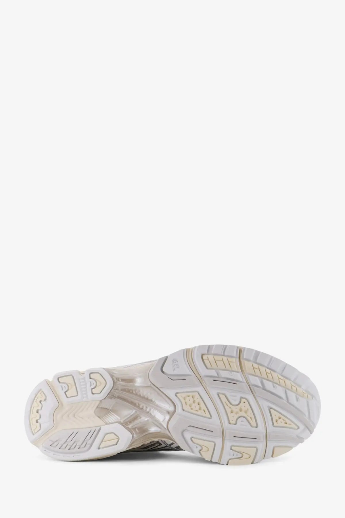 A translucent white and beige rubber sole with geometric tread and asics logo on the side of men’s gel nimbus mesh sneakers
