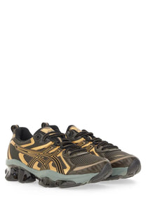 Asics men’s gel quantum kinetic sneaker in black and gold with mesh upper, bold stripes, and chunky translucent sole