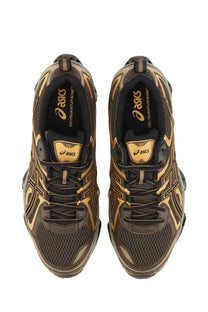 Asics men’s gel quantum kinetic sneaker in black and gold with mesh upper and bold geometric patterns