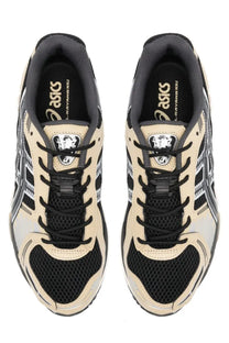 Beige and black asics unisex gel kayano 10 sneakers with mesh panels rubber soles and silver branding accents