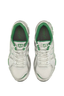 Asics unisex gel kayano sneaker white with white and green mesh upper silver accents and cushioned sole