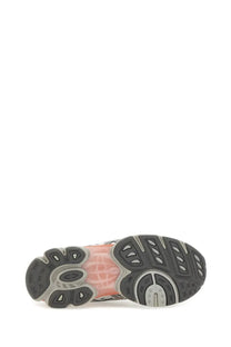 The back side of an asics unisex gel nimbus sneaker with a translucent pink midsole and black gray rubber outsole