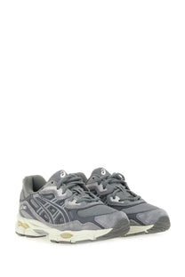 Gray ASICS unisex gel nyc running shoes with textured mesh and suede upper, white laces, and subtle gold midsole details