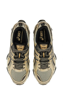 Beige and black asics unisex gel quantum kinetic running shoes with mesh uppers and gold branding in multicolor design