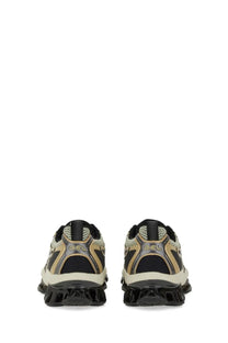 Asics unisex gel quantum kinetic sneaker in black and beige with textured mesh upper metallic gold accents and chunky sole
